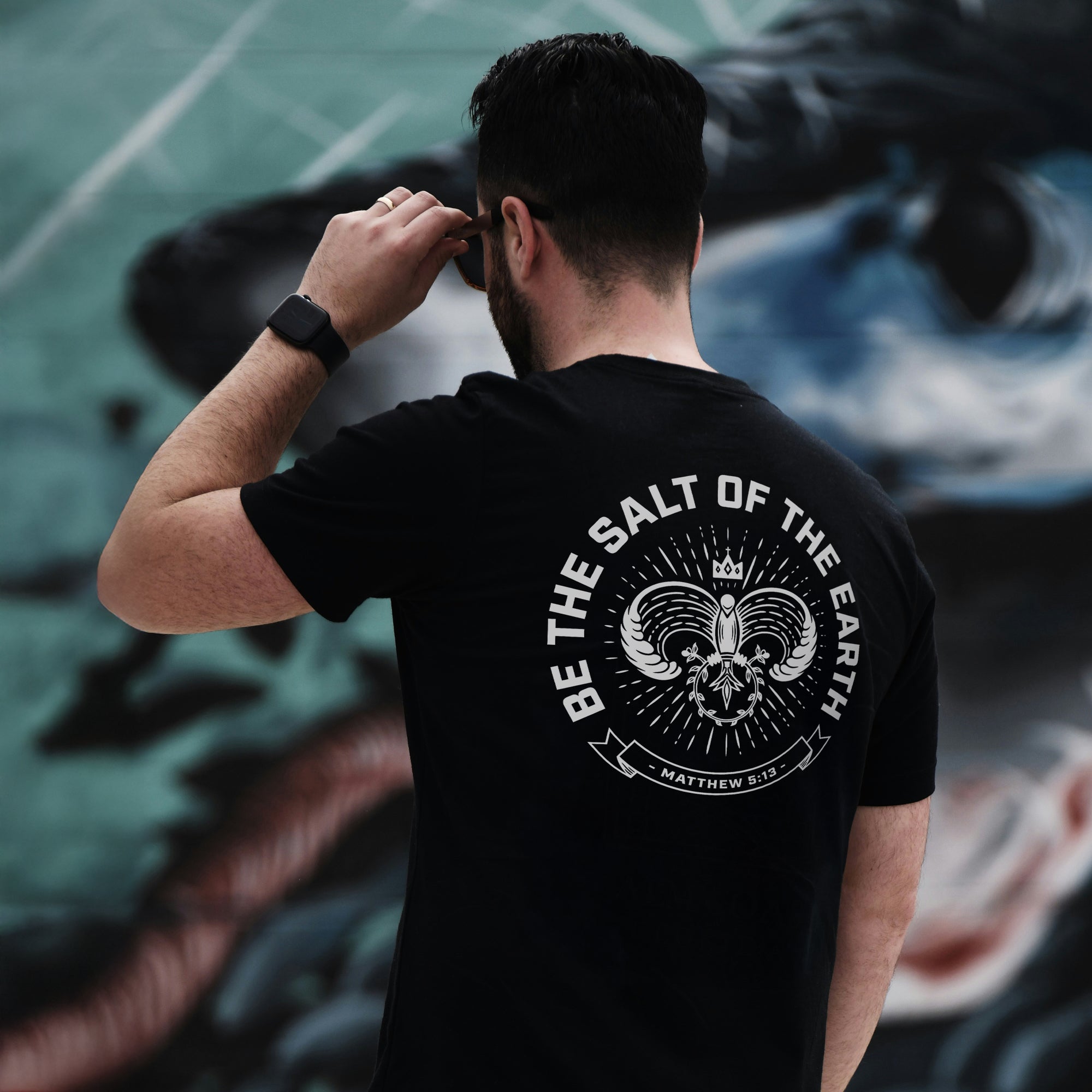 Close-up of the Salt of the Earth T-shirt by Dove at Dawn, showing the fabric texture and detailed print design.